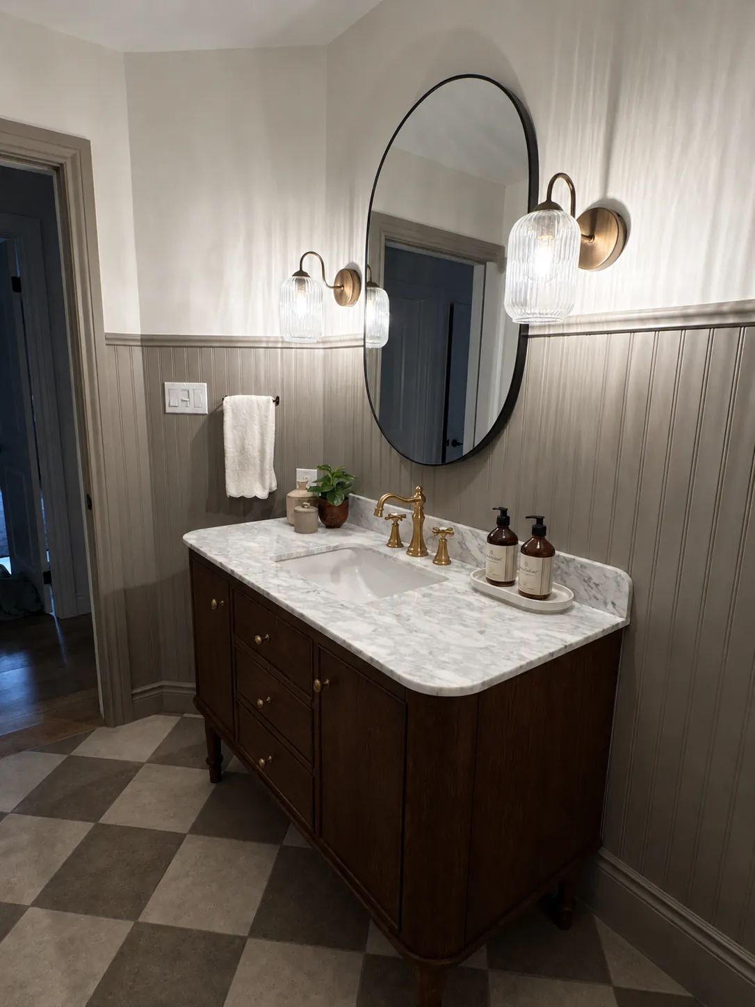 Bathroom with checkered floor and walnut vanity