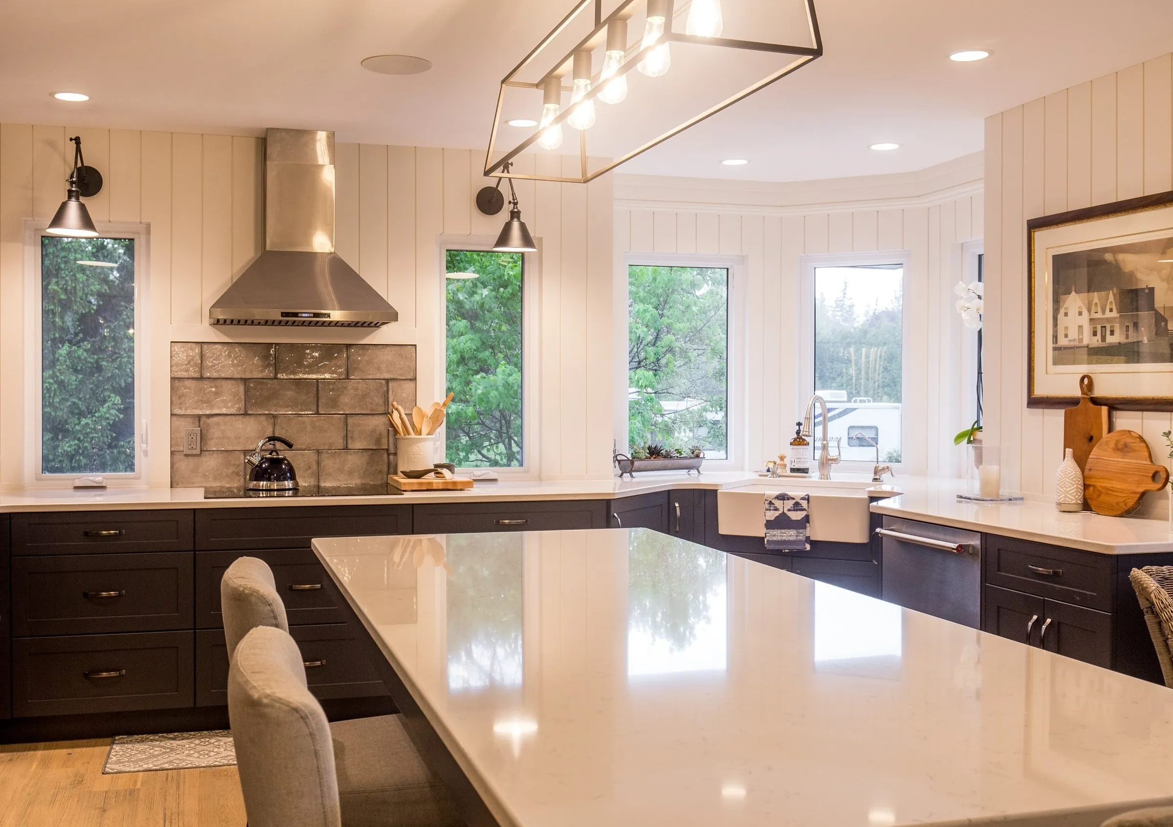 Kitchen with a stainless range hood and large island