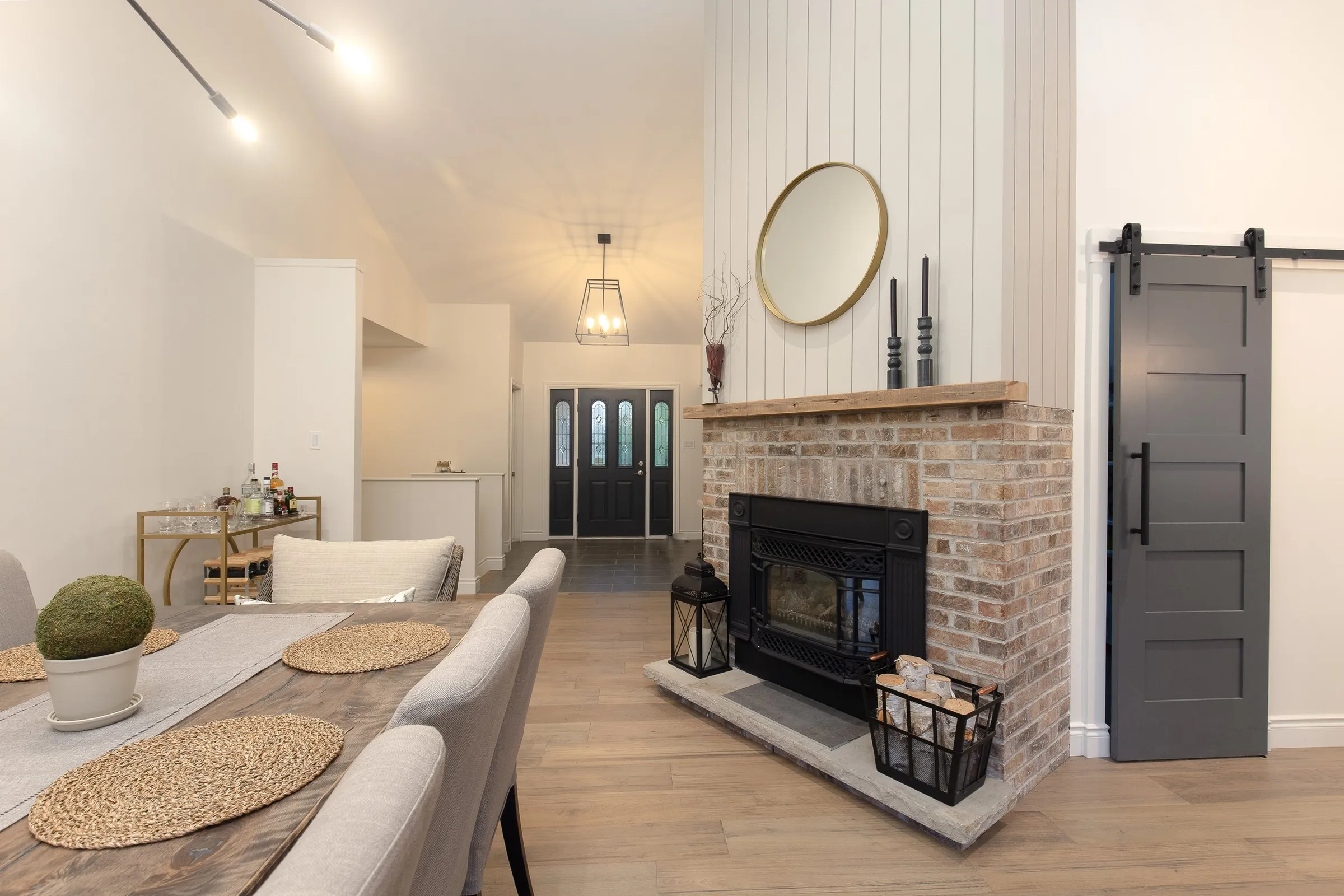 Living room with a brick fireplace and barn door