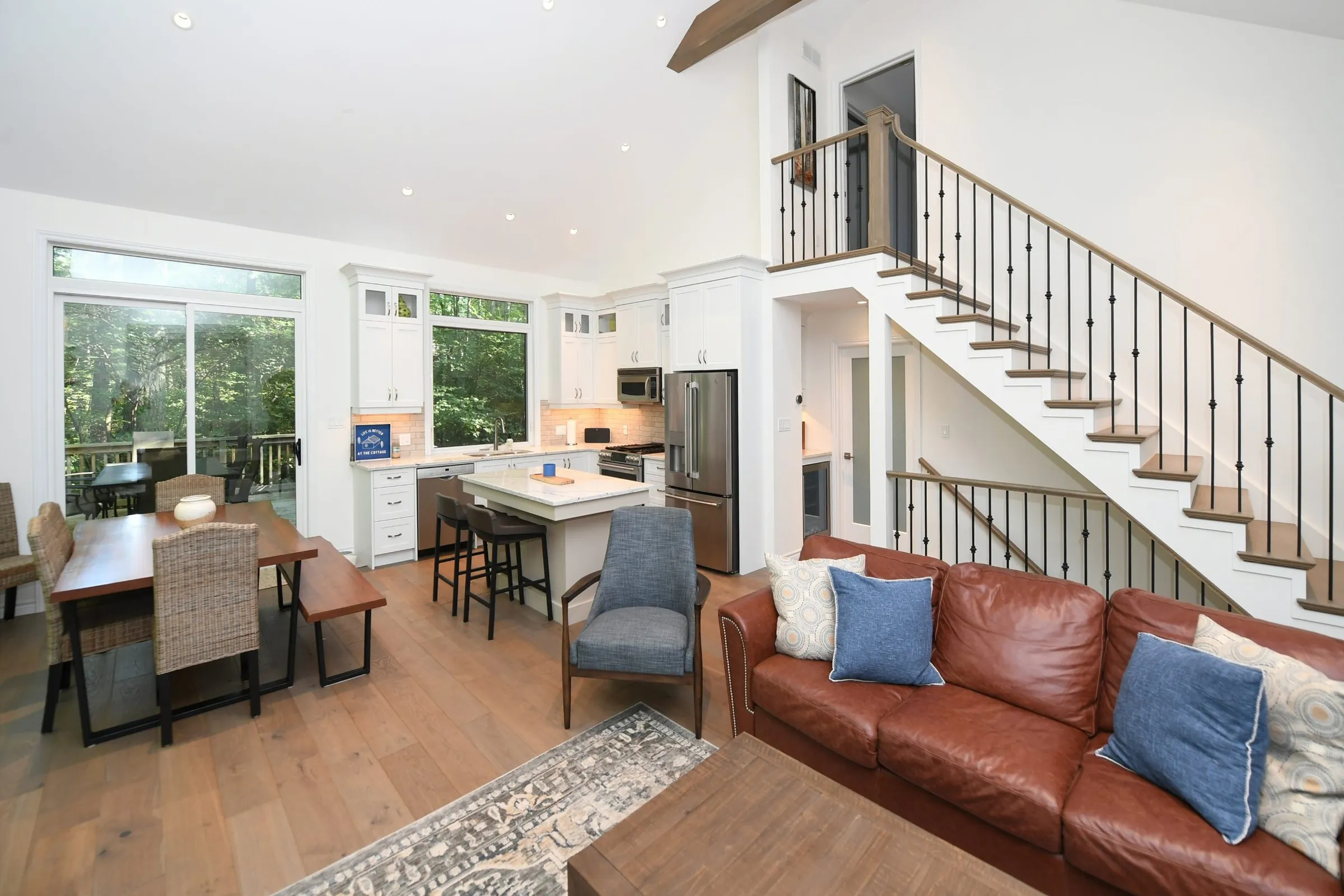 Cottage living room with timber beams and navy armchairs