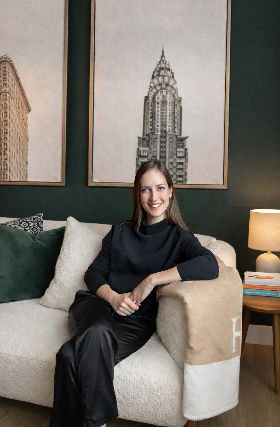 Jenn Cartwright, interior designer and founder of Slate and Company, seated in a green living room