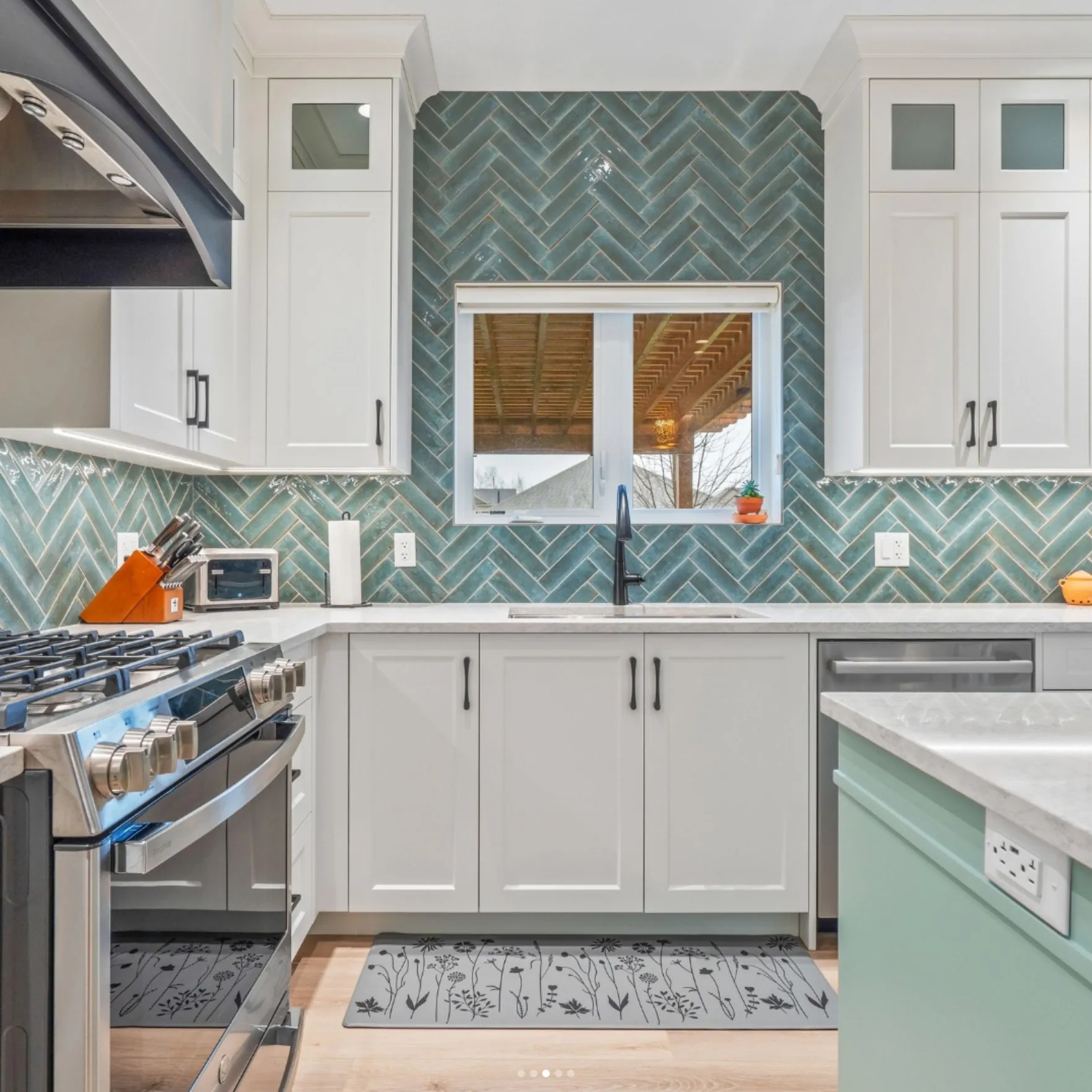 Kitchen with a herringbone teal backsplash